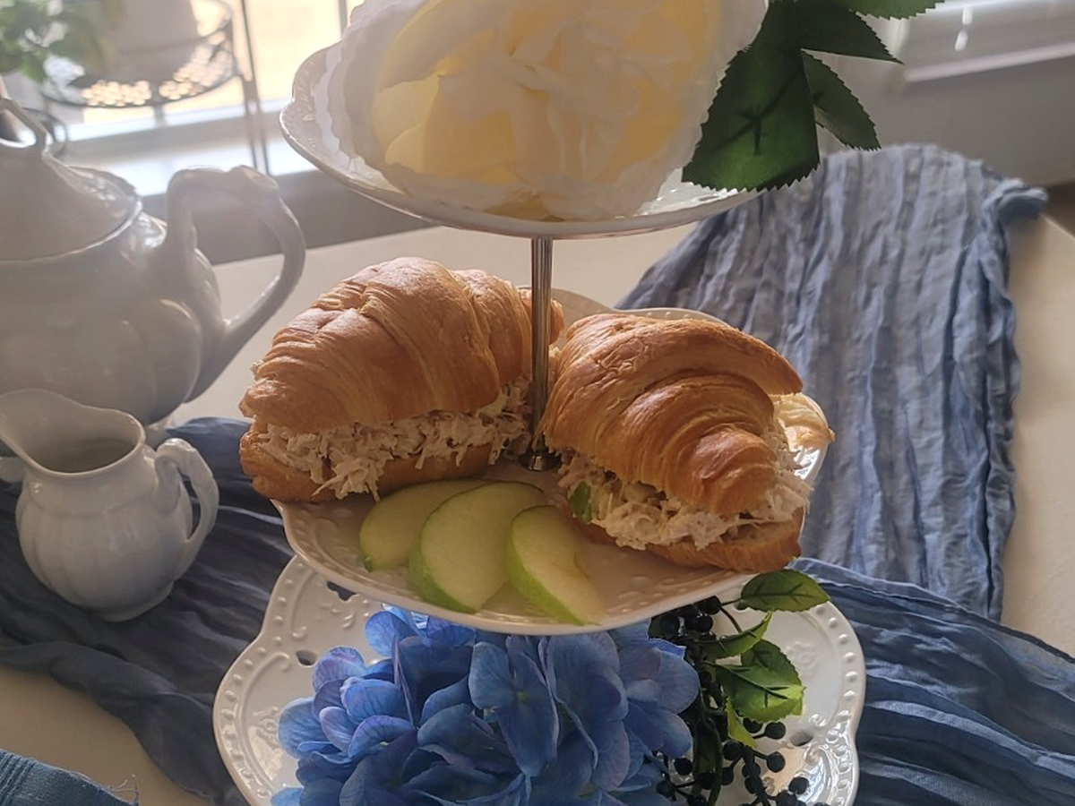 Bloom and Grace tiered tray with chicken salad croissants, green apple and blue florals